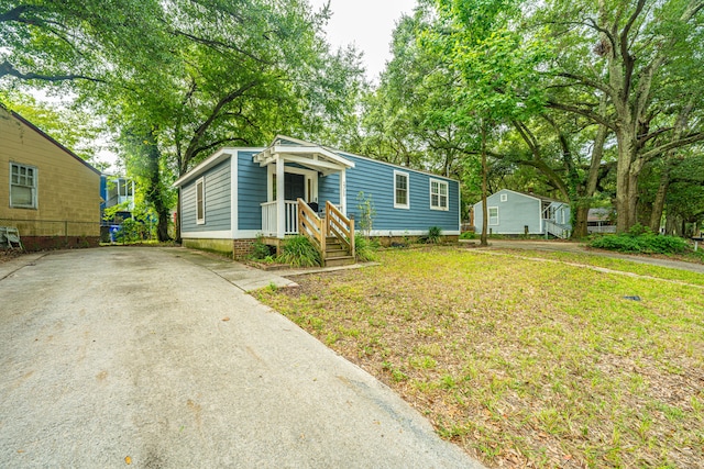 bungalow-style house featuring a front yard