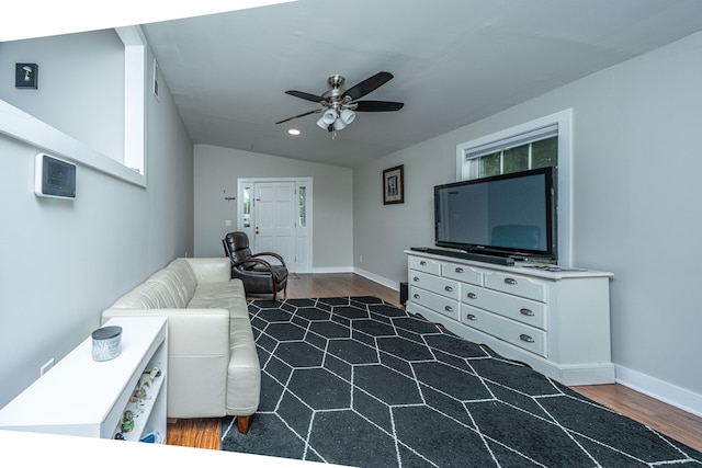 living room featuring dark wood-type flooring, lofted ceiling, and ceiling fan