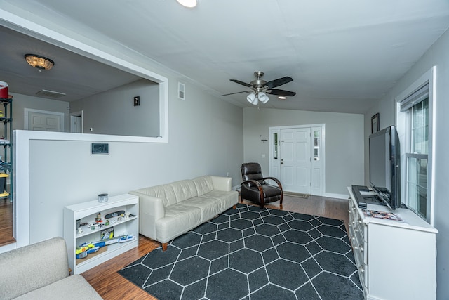 living room featuring lofted ceiling, ceiling fan, and dark hardwood / wood-style floors