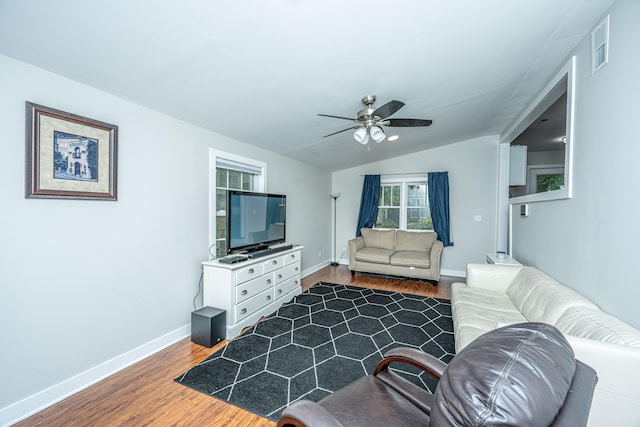 living room with ceiling fan, dark hardwood / wood-style flooring, and vaulted ceiling