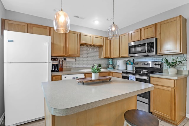 kitchen featuring a kitchen bar, decorative backsplash, stainless steel appliances, and decorative light fixtures