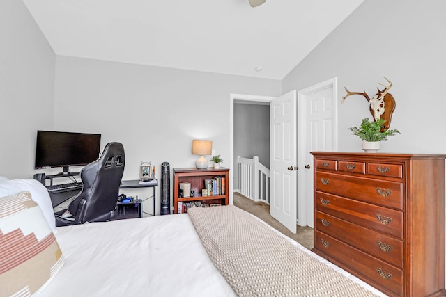 bedroom featuring carpet floors and vaulted ceiling