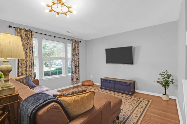 living room with wood-type flooring and a notable chandelier