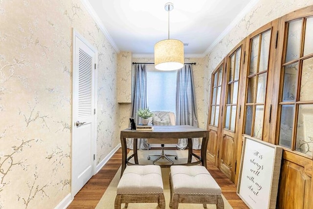 dining space with wallpapered walls, crown molding, baseboards, and wood finished floors