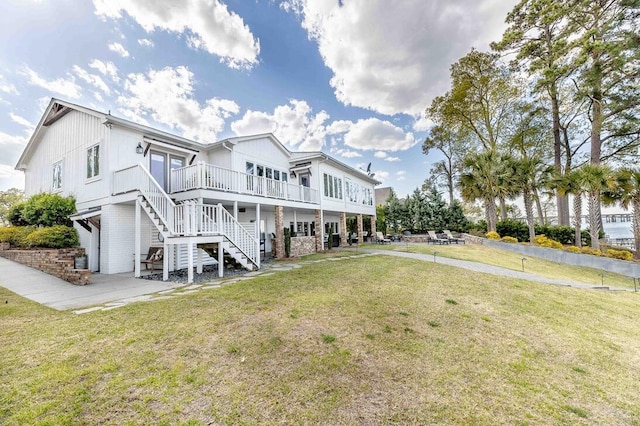 rear view of house featuring a patio area, stairway, a deck, and a lawn