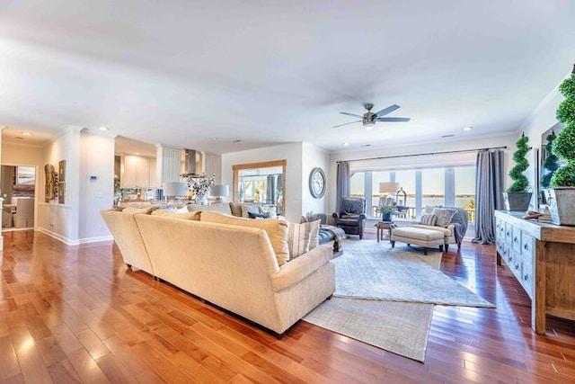 living area featuring crown molding, baseboards, recessed lighting, a ceiling fan, and hardwood / wood-style floors