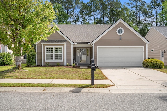 view of front of home with roof with shingles, an attached garage, a front lawn, and concrete driveway