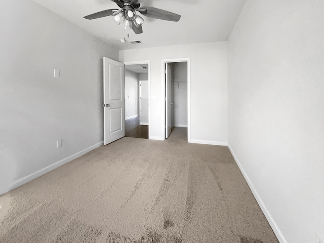 unfurnished bedroom with a ceiling fan, visible vents, baseboards, a closet, and carpet