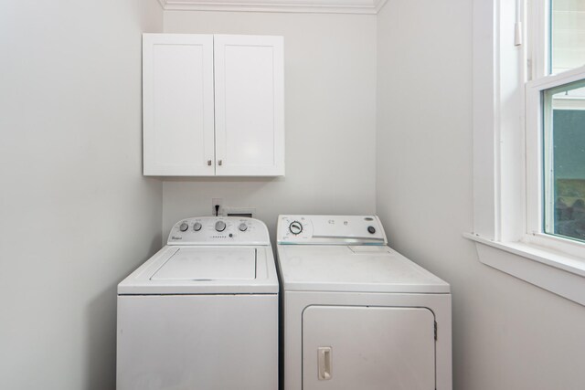 laundry area featuring cabinets and washer and clothes dryer