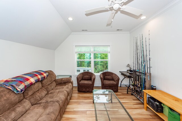 living room with ornamental molding, lofted ceiling, ceiling fan, and light hardwood / wood-style floors