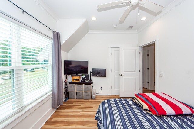 bedroom with crown molding, ceiling fan, and light wood-type flooring