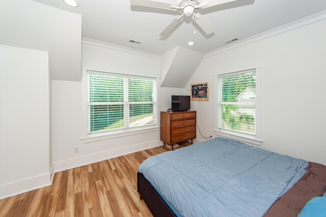 bedroom featuring ceiling fan, ornamental molding, and light wood-type flooring