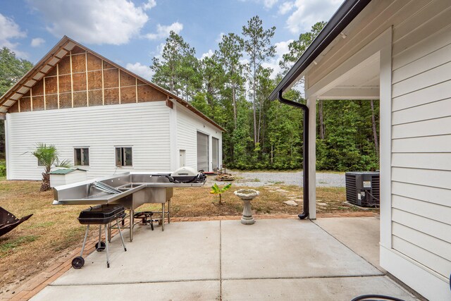 view of patio / terrace with central AC unit and a grill