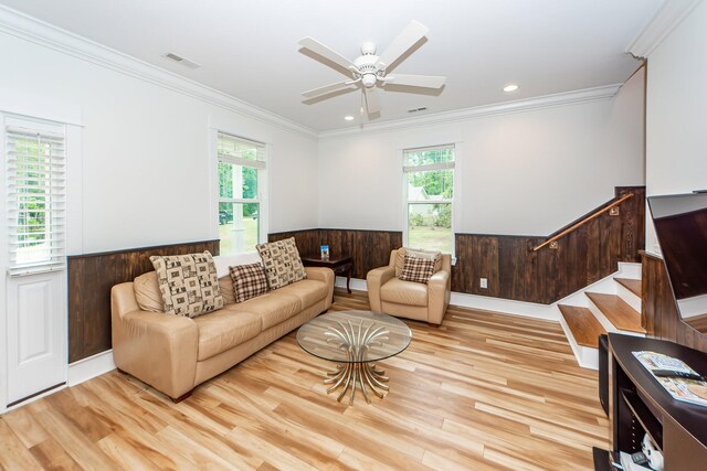 living room with plenty of natural light, ceiling fan, ornamental molding, and light hardwood / wood-style floors