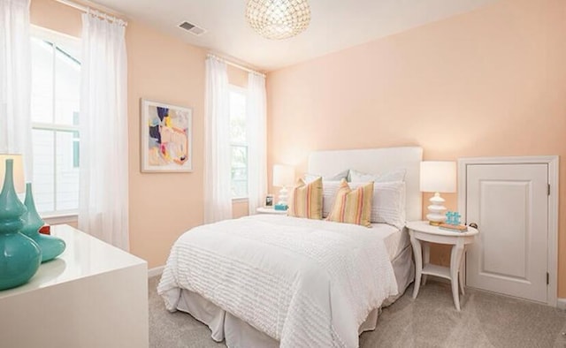 774 Clay Field Trl, Summerville, SC 29485 - bedroom with light colored carpet, multiple windows, baseboards, and a chandelier