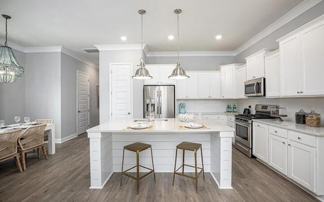 774 Clay Field Trl, Summerville, SC 29485 - kitchen with stainless steel appliances, a breakfast bar area, ornamental molding, white cabinetry, and a center island with sink