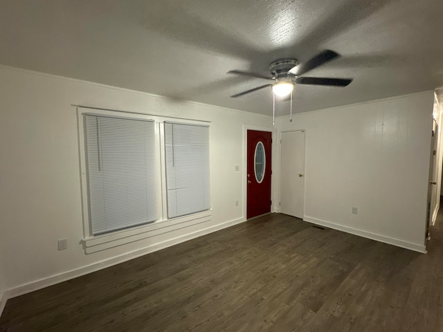 unfurnished room with dark hardwood / wood-style flooring and ceiling fan