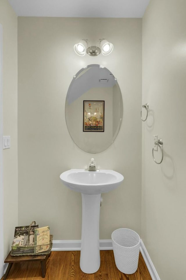 bathroom featuring wood finished floors and baseboards