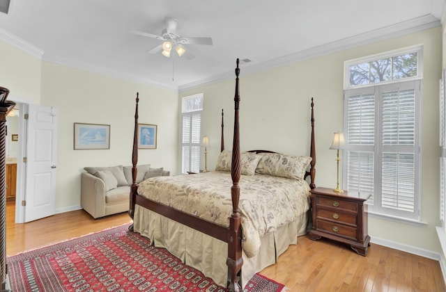 bedroom with light wood-style flooring, multiple windows, baseboards, and crown molding