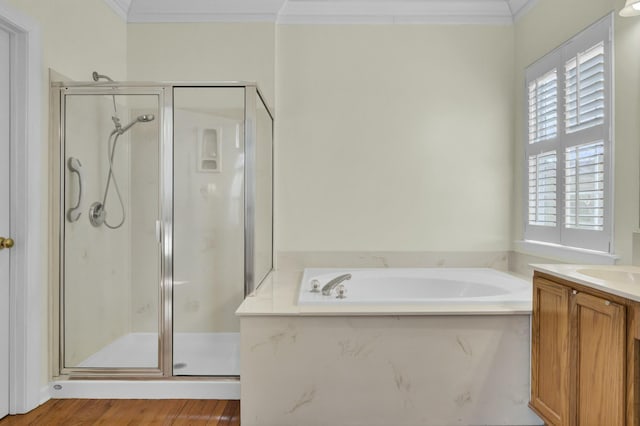 full bath featuring a stall shower, crown molding, and vanity