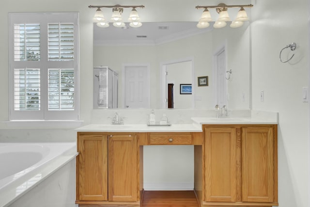 bathroom featuring a garden tub, crown molding, double vanity, a stall shower, and a sink