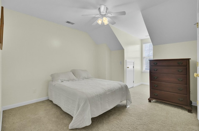 bedroom with vaulted ceiling, baseboards, visible vents, and light colored carpet