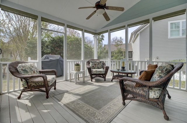 sunroom / solarium featuring ceiling fan and vaulted ceiling