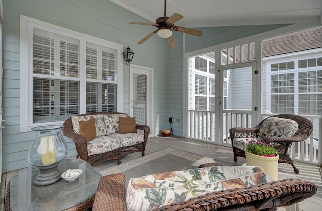 sunroom featuring vaulted ceiling and ceiling fan