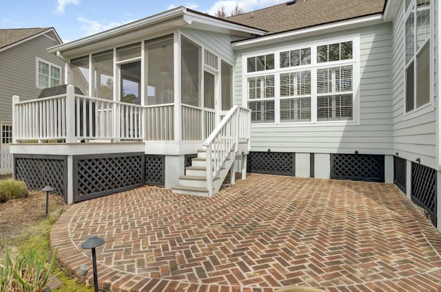 exterior space with a sunroom and roof with shingles