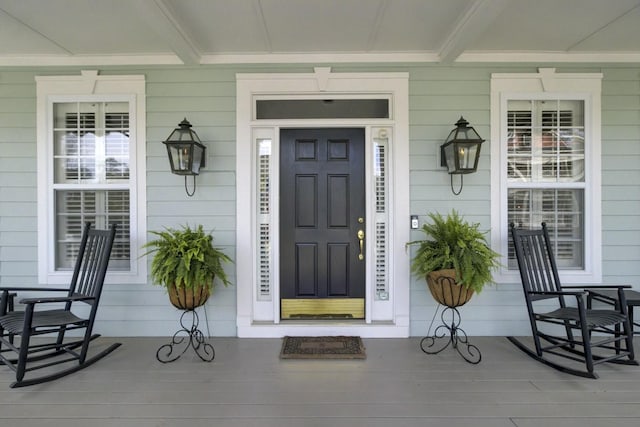 view of exterior entry with covered porch