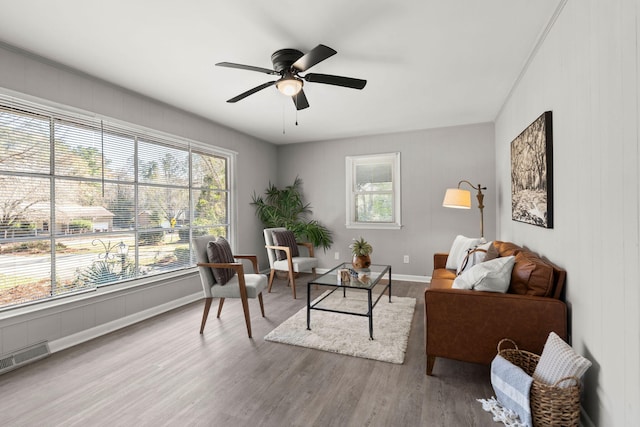 living room featuring hardwood / wood-style flooring and ceiling fan