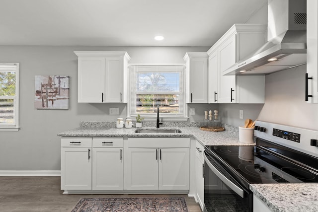 kitchen featuring dark hardwood / wood-style flooring, wall chimney exhaust hood, stainless steel electric range oven, sink, and white cabinetry