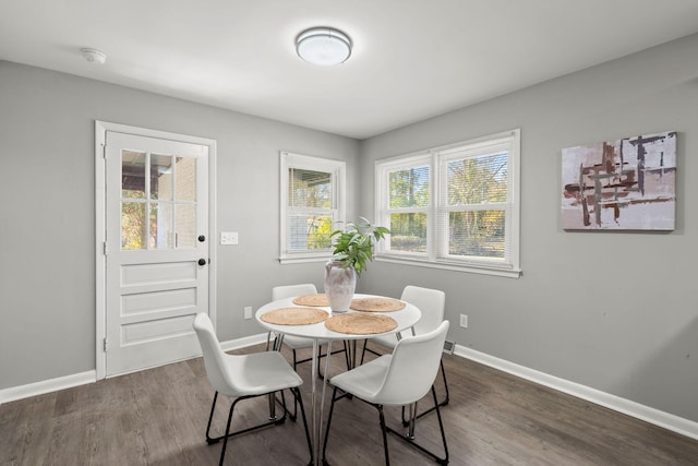 dining space with dark hardwood / wood-style floors