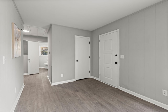 unfurnished room featuring wood-type flooring and ornamental molding