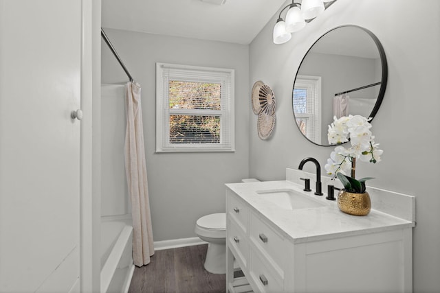 full bathroom featuring hardwood / wood-style floors, vanity, toilet, and shower / bathtub combination with curtain