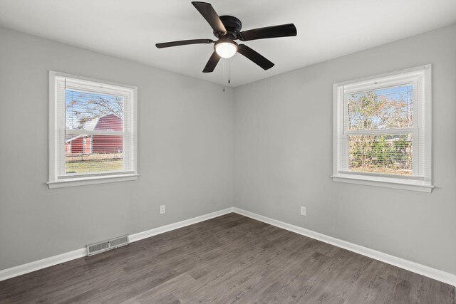 unfurnished room with ceiling fan and dark hardwood / wood-style flooring