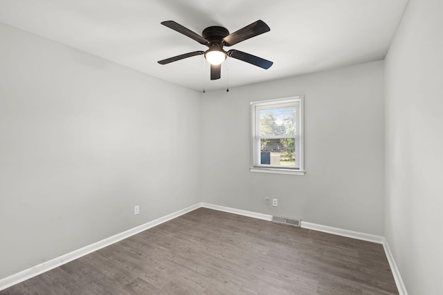 spare room with ceiling fan and dark hardwood / wood-style flooring