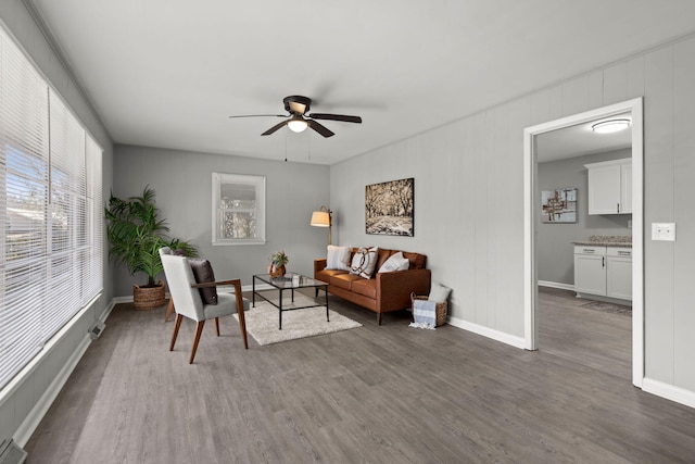 living room featuring ceiling fan and dark wood-type flooring