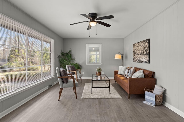 living room featuring wood-type flooring and ceiling fan