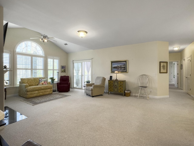 carpeted living room featuring a ceiling fan, lofted ceiling, plenty of natural light, and baseboards