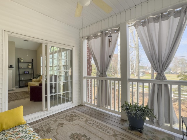 sunroom featuring a ceiling fan and a wealth of natural light