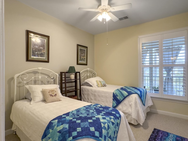 bedroom with a ceiling fan, carpet, visible vents, and baseboards