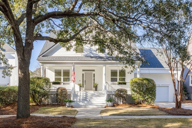 view of front of home with a porch, a shingled roof, driveway, and a garage