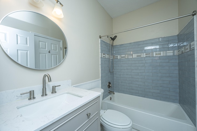 full bathroom with vanity, toilet, and tiled shower / bath combo