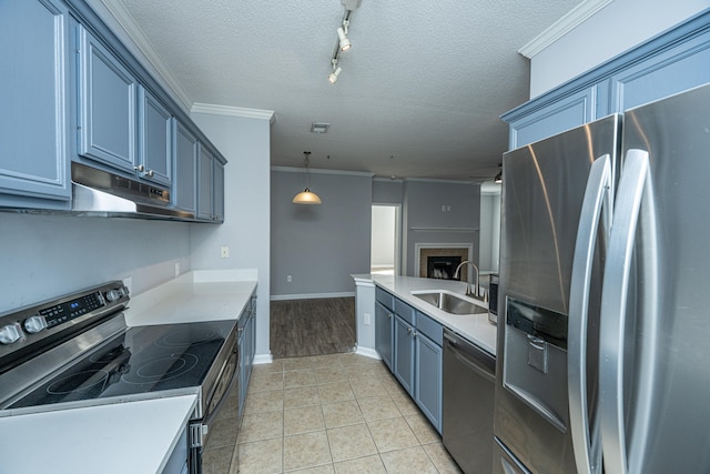 kitchen with sink, crown molding, pendant lighting, appliances with stainless steel finishes, and a textured ceiling