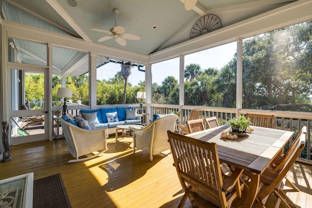 sunroom / solarium featuring ceiling fan and vaulted ceiling with beams