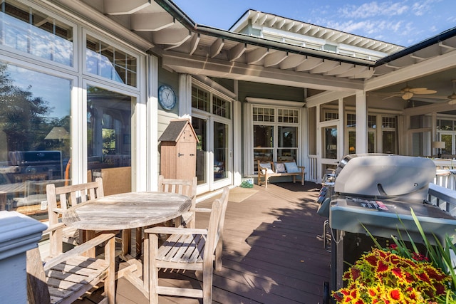 wooden terrace featuring ceiling fan and grilling area