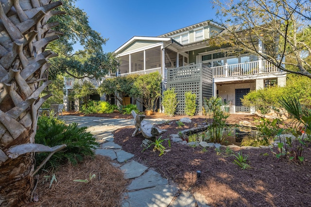 rear view of house featuring a sunroom