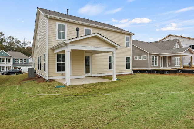 rear view of property with a yard and a patio