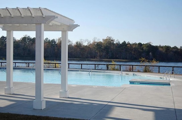 view of swimming pool featuring a patio area, a water view, and a pergola